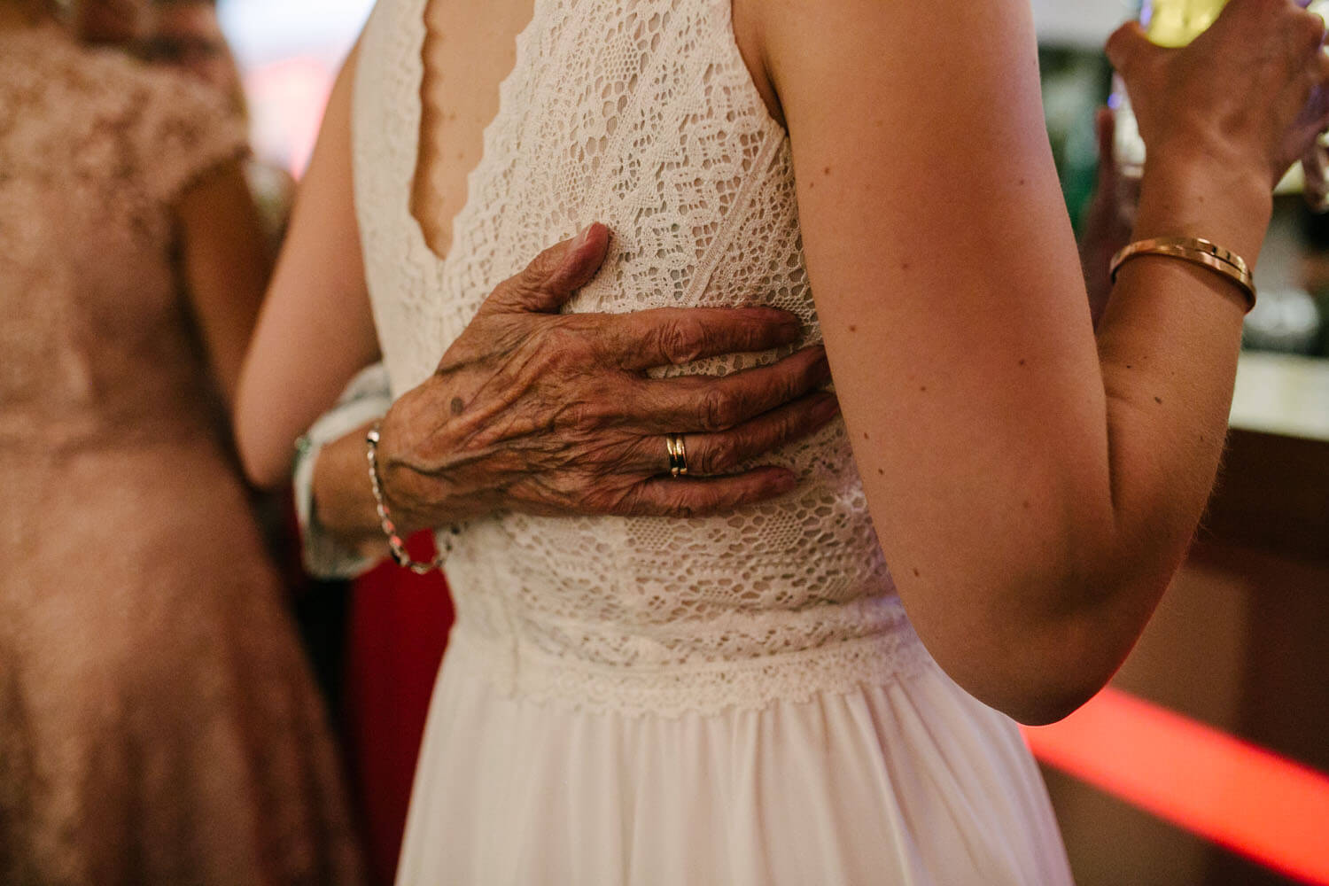 Nahaufnahme der Hand der Grossmutter auf dem Hochzeitskleid. Hochzeit in Melle.